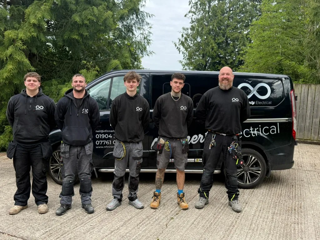 Nfinnerty Electrical team standing beside their service van