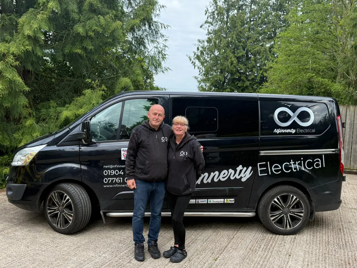Nfinnerty Electrical representatives standing beside their service van